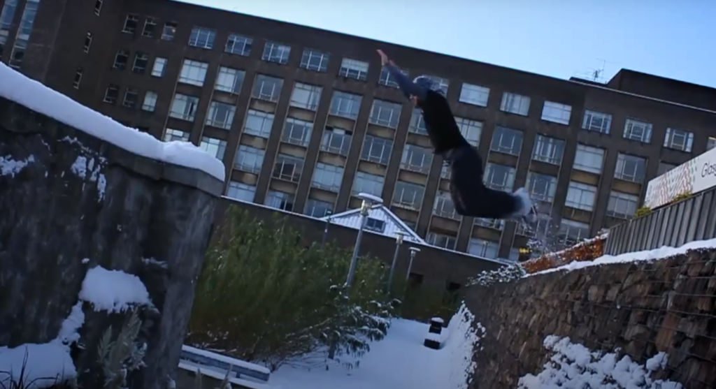 Parkour jump in the snow. Parkour in winter 
